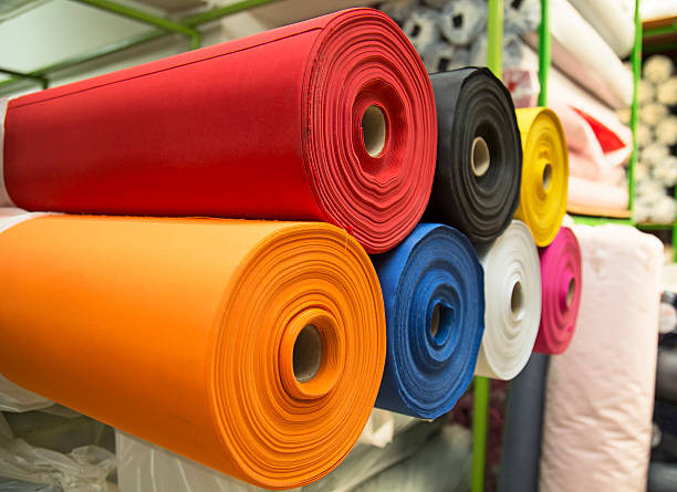 colorful material fabric rolls in warehouse